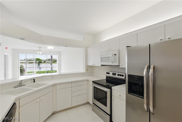 3460 W Crown Pointe Blvd Unit 101, Naples, FL 34112 - kitchen with stainless steel appliances, a sink, a ceiling fan, light countertops, and light tile patterned flooring