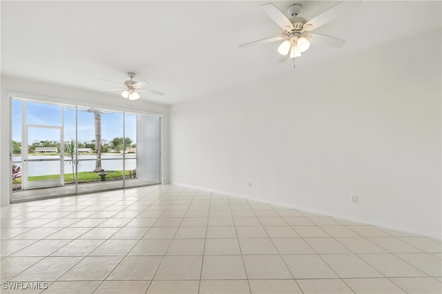 3460 W Crown Pointe Blvd Unit 101, Naples, FL 34112 - unfurnished room featuring ceiling fan, a water view, light tile patterned floors, and baseboards