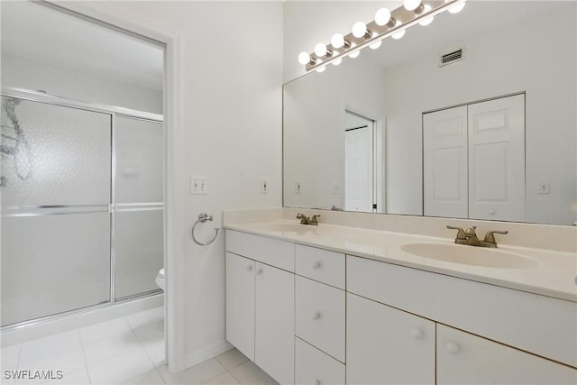 3460 W Crown Pointe Blvd Unit 101, Naples, FL 34112 - full bathroom with a shower stall, toilet, double vanity, and tile patterned flooring