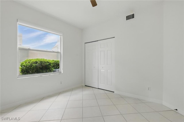 3460 W Crown Pointe Blvd Unit 101, Naples, FL 34112 - unfurnished bedroom featuring baseboards, a closet, and ceiling fan