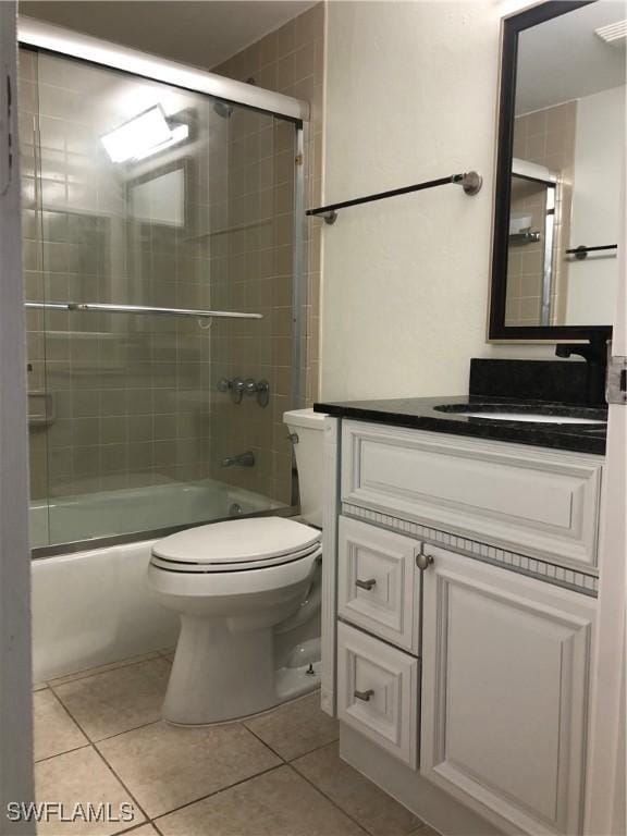 4510 N Key Dr Unit 302, North Fort Myers, FL 33903 - bathroom with tile patterned floors, toilet, shower / bath combination with glass door, and vanity