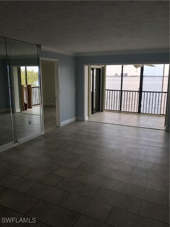 4510 N Key Dr Unit 302, North Fort Myers, FL 33903 - empty room featuring crown molding, baseboards, and a textured ceiling