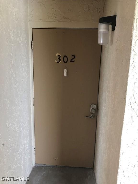 4510 N Key Dr Unit 302, North Fort Myers, FL 33903 - doorway to property with stucco siding