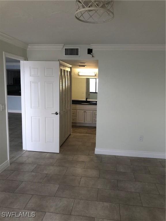 4510 N Key Dr Unit 302, North Fort Myers, FL 33903 - empty room featuring baseboards, crown molding, and a sink