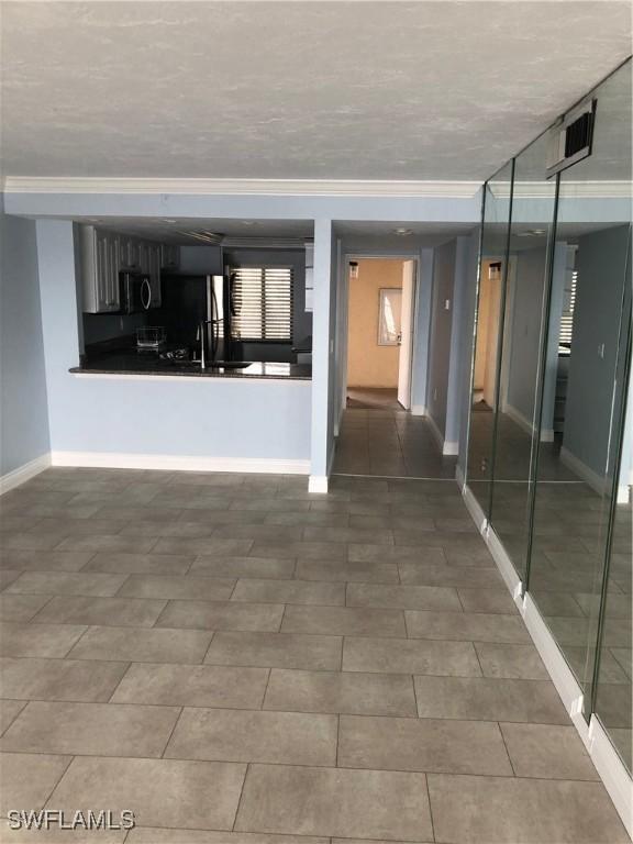 4510 N Key Dr Unit 302, North Fort Myers, FL 33903 - empty room with baseboards and ornamental molding