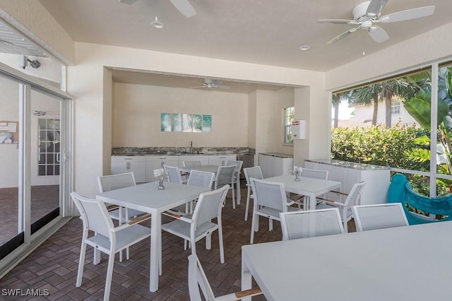 26986 Montego Pointe Ct Unit 202, Bonita Springs, FL 34134 - dining room with ceiling fan, brick patterned floors, and plenty of natural light