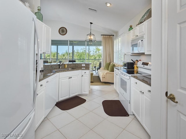 26986 Montego Pointe Ct Unit 202, Bonita Springs, FL 34134 - kitchen featuring white appliances, lofted ceiling, white cabinetry, a sink, and dark stone counters