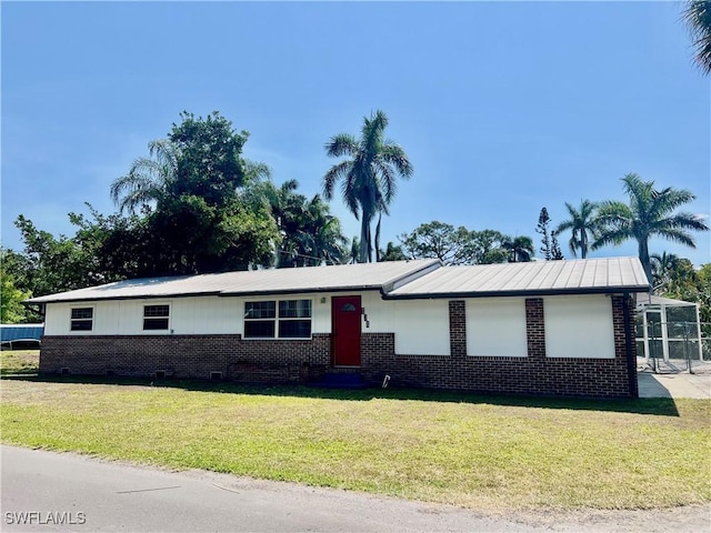 134 Standish Cir, North Fort Myers, FL 33903 - view of front of house with brick siding and a front lawn