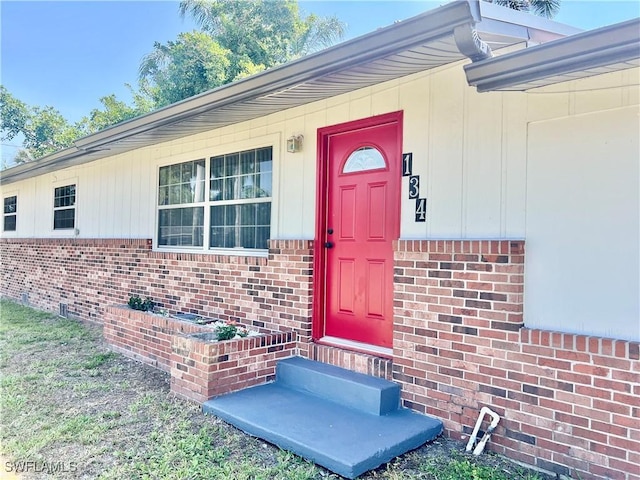 134 Standish Cir, North Fort Myers, FL 33903 - doorway to property with brick siding