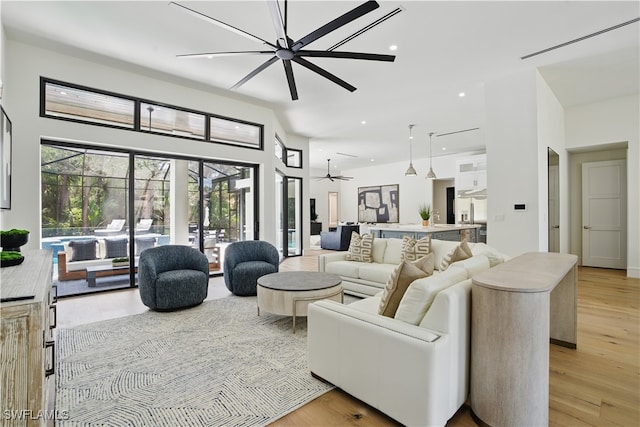 24721 Bay Bean Ct, Bonita Springs, FL 34134 - living room featuring a towering ceiling, healthy amount of natural light, light wood-style flooring, ceiling fan, and recessed lighting