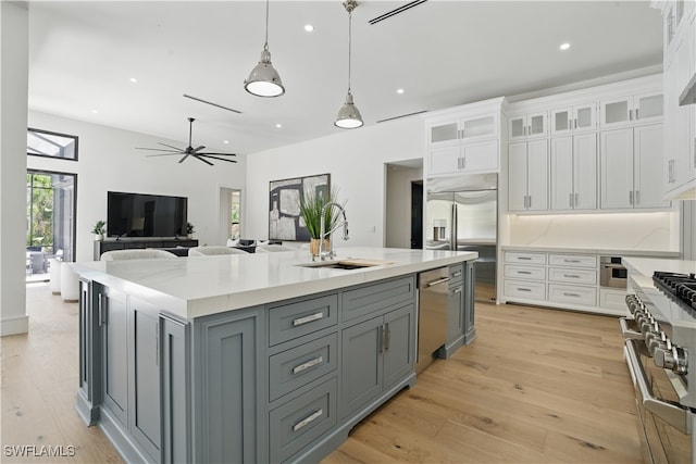 24721 Bay Bean Ct, Bonita Springs, FL 34134 - kitchen featuring a sink, high quality appliances, white cabinets, gray cabinetry, and a large island with sink