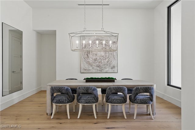 24721 Bay Bean Ct, Bonita Springs, FL 34134 - dining space with a chandelier, light wood-type flooring, and baseboards