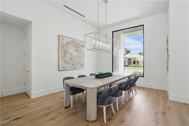 24721 Bay Bean Ct, Bonita Springs, FL 34134 - dining space featuring light wood-style floors, a chandelier, and baseboards