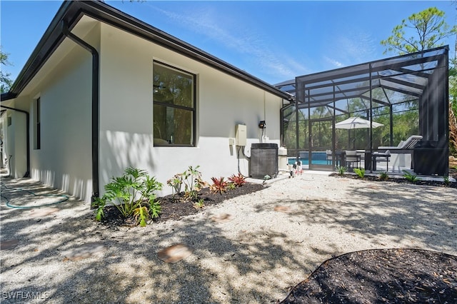 24721 Bay Bean Ct, Bonita Springs, FL 34134 - rear view of property with stucco siding, a patio area, a lanai, and an outdoor pool