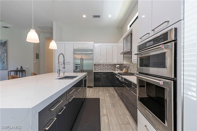10138 Palazzo Dr, Naples, FL 34119 - kitchen with appliances with stainless steel finishes, a sink, white cabinets, decorative backsplash, and modern cabinets