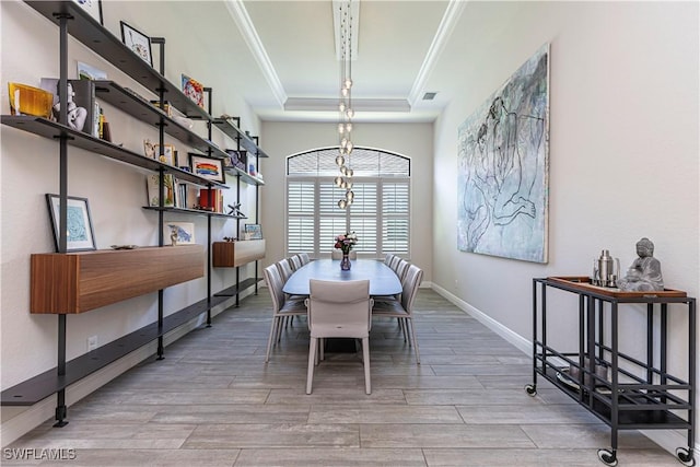 10138 Palazzo Dr, Naples, FL 34119 - dining room featuring crown molding, a tray ceiling, wood finished floors, baseboards, and a chandelier