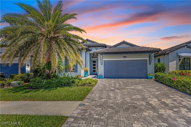 10138 Palazzo Dr, Naples, FL 34119 - single story home with decorative driveway, an attached garage, and stucco siding