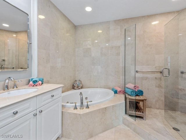 1079 Bald Eagle Dr Unit N604, Marco Island, FL 34145 - bathroom with a tub with jets, vanity, a stall shower, tile patterned floors, and recessed lighting