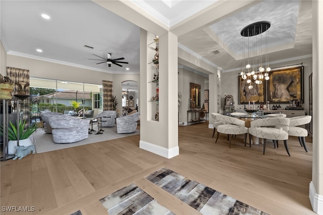 12501 Walden Run Dr, Fort Myers, FL 33913 - living room featuring ornamental molding, wood finished floors, a chandelier, ceiling fan, and baseboards