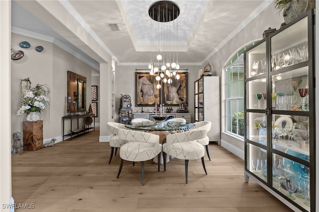12501 Walden Run Dr, Fort Myers, FL 33913 - dining space featuring a raised ceiling, a chandelier, light wood-style floors, and baseboards