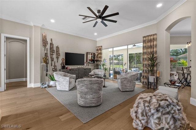 12501 Walden Run Dr, Fort Myers, FL 33913 - living area featuring ceiling fan, arched walkways, healthy amount of natural light, crown molding, and light wood-style floors