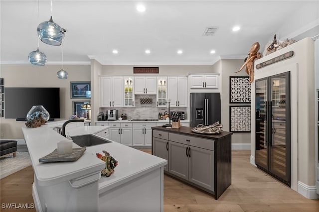 12501 Walden Run Dr, Fort Myers, FL 33913 - kitchen with black appliances, a center island with sink, ornamental molding, backsplash, and a sink