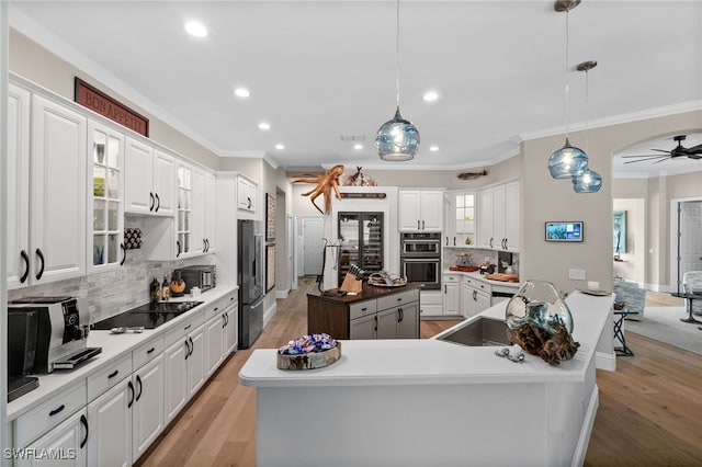 12501 Walden Run Dr, Fort Myers, FL 33913 - kitchen with crown molding, high end refrigerator, tasteful backsplash, recessed lighting, and a kitchen island