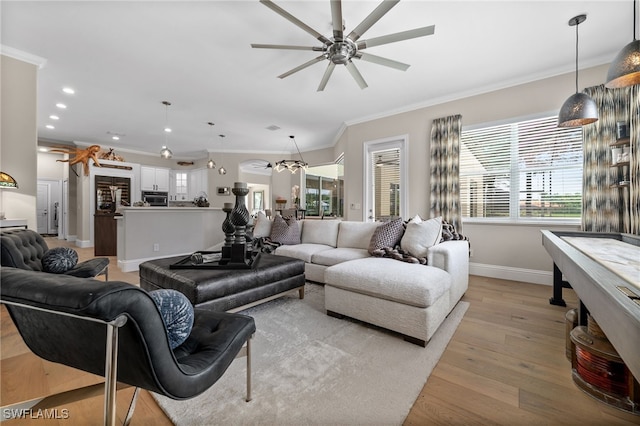 12501 Walden Run Dr, Fort Myers, FL 33913 - living area with crown molding, ceiling fan, baseboards, light wood-style flooring, and plenty of natural light