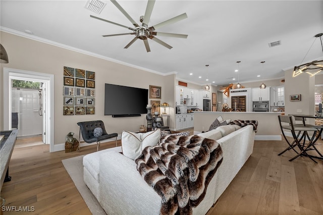 12501 Walden Run Dr, Fort Myers, FL 33913 - living area with ceiling fan, crown molding, recessed lighting, light wood-type flooring, and baseboards