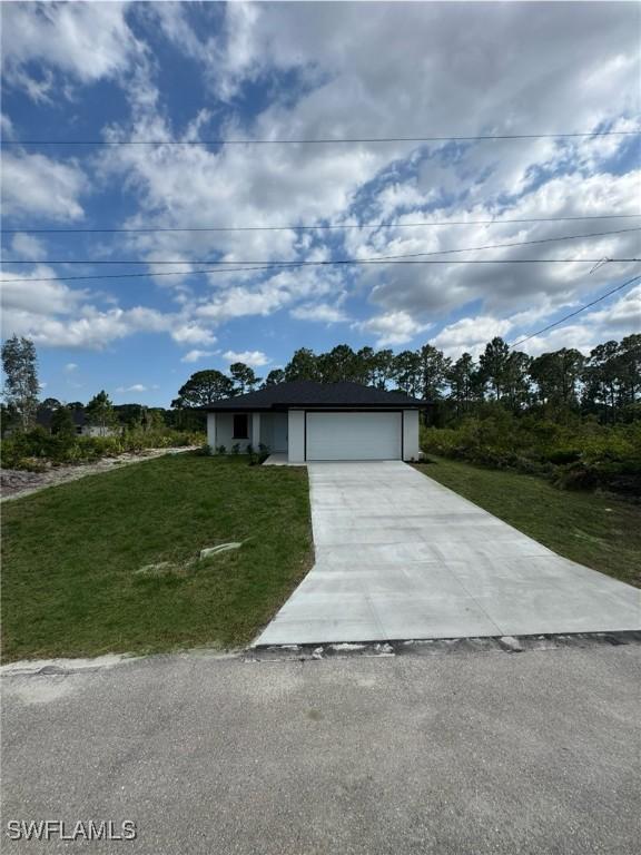2917 50th St W, Lehigh Acres, FL 33971 - view of front of property with concrete driveway, a front lawn, and an attached garage