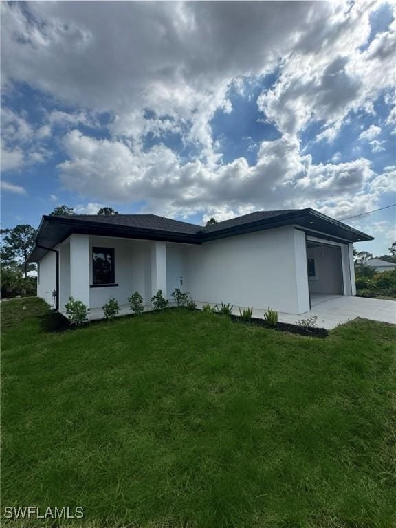 2917 50th St W, Lehigh Acres, FL 33971 - view of front of property with concrete driveway, a front yard, a garage, and stucco siding