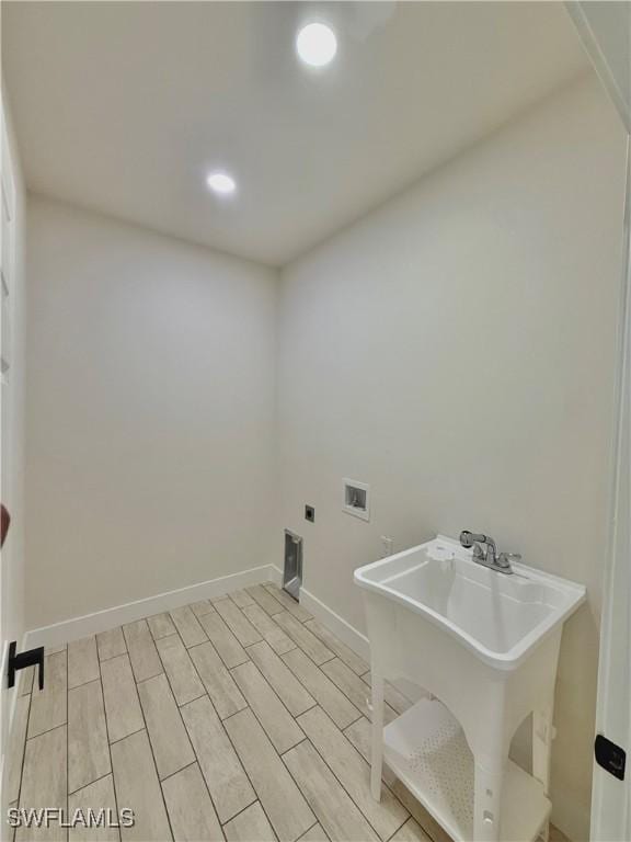 2917 50th St W, Lehigh Acres, FL 33971 - washroom with washer hookup, baseboards, recessed lighting, and light wood finished floors