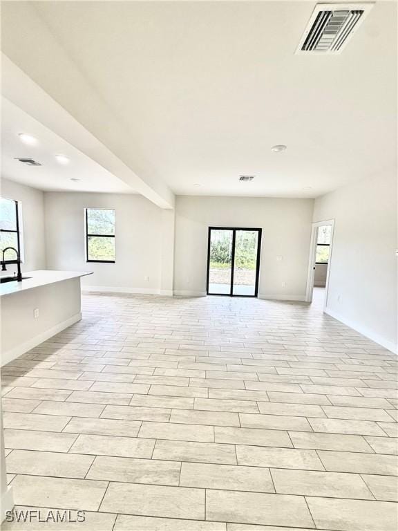 2917 50th St W, Lehigh Acres, FL 33971 - unfurnished living room with baseboards, recessed lighting, and a sink