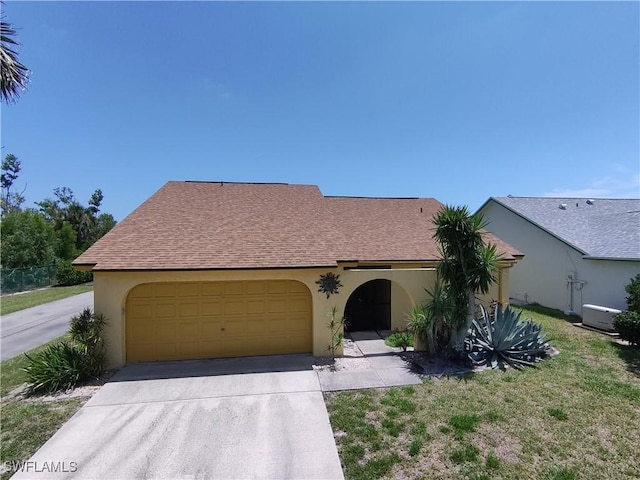 11511 Cinnamon Cove Blvd, Fort Myers, FL 33908 - view of front of house featuring stucco siding, concrete driveway, an attached garage, and a shingled roof