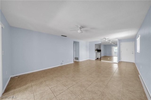 198 Joel Blvd Unit 5, Lehigh Acres, FL 33936 - unfurnished living room featuring a ceiling fan, light tile patterned flooring, and baseboards