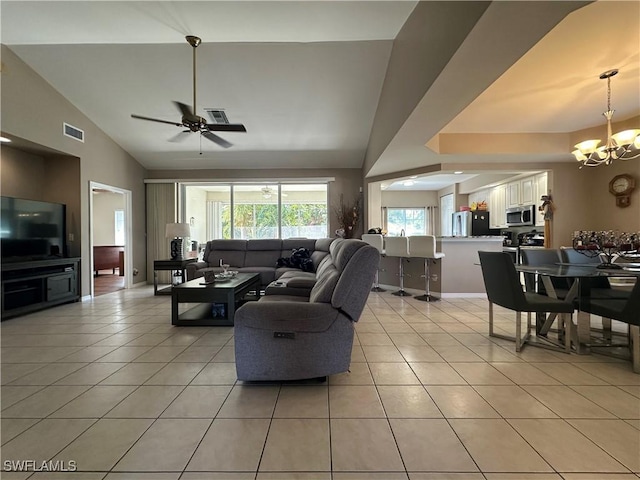 4219 Tequesta Dr, Estero, FL 33928 - living room featuring light tile patterned floors, a chandelier, a ceiling fan, and high vaulted ceiling