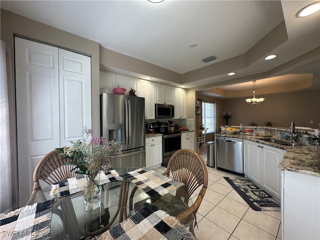 4219 Tequesta Dr, Estero, FL 33928 - kitchen featuring appliances with stainless steel finishes, a sink, light tile patterned flooring, a chandelier, and recessed lighting