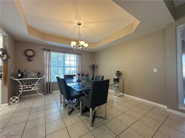 4219 Tequesta Dr, Estero, FL 33928 - dining area featuring a raised ceiling, a chandelier, light tile patterned floors, and baseboards