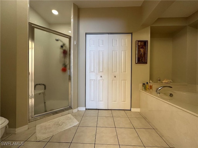 4219 Tequesta Dr, Estero, FL 33928 - bathroom with tile patterned floors, a garden tub, a stall shower, and baseboards