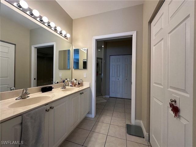 4219 Tequesta Dr, Estero, FL 33928 - bathroom featuring tile patterned floors, double vanity, and baseboards