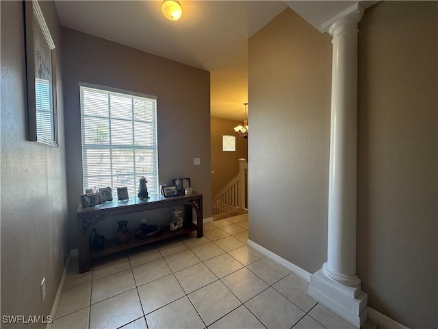4219 Tequesta Dr, Estero, FL 33928 - hallway with ornate columns, light tile patterned floors, and baseboards