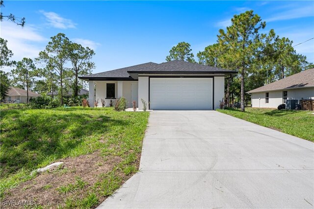 2907 55th St W, Lehigh Acres, FL 33971 - view of front facade featuring concrete driveway, a garage, a front yard, stucco siding, and roof with shingles
