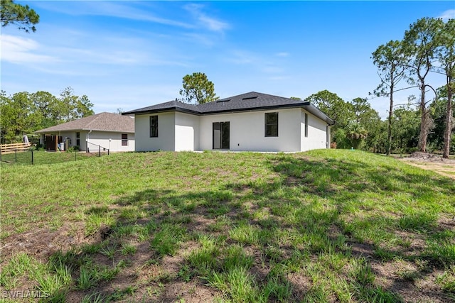 2907 55th St W, Lehigh Acres, FL 33971 - rear view of house featuring stucco siding