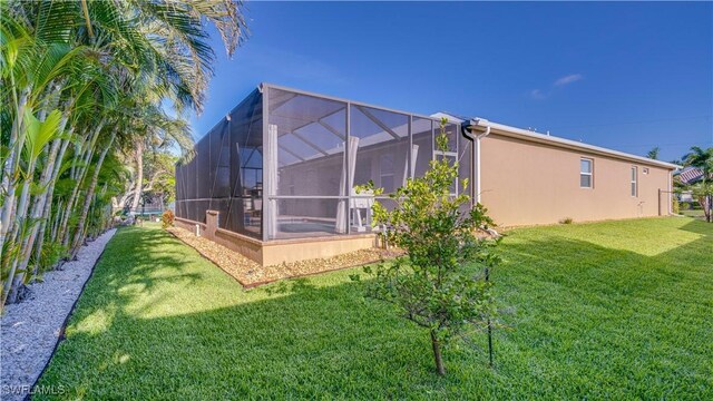 2541 SW 32nd Ln, Cape Coral, FL 33914 - back of property featuring stucco siding and glass enclosure
