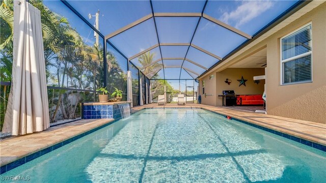 2541 SW 32nd Ln, Cape Coral, FL 33914 - outdoor pool with a patio area, grilling area, glass enclosure, and ceiling fan