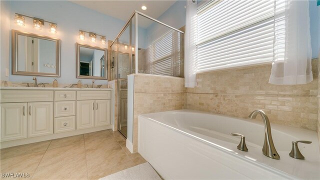 2541 SW 32nd Ln, Cape Coral, FL 33914 - full bathroom with a garden tub, double vanity, a stall shower, and tile patterned floors