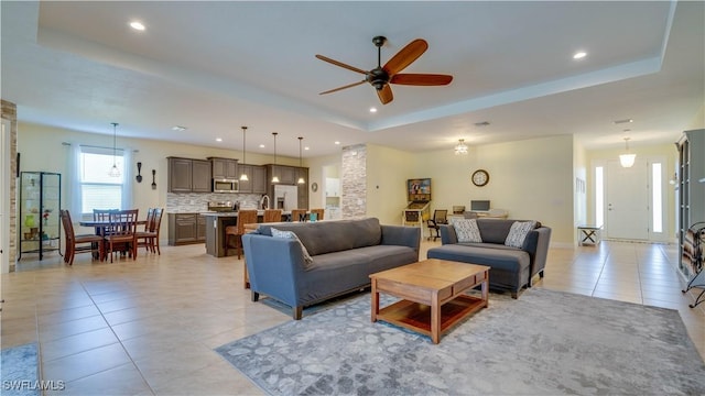 2541 SW 32nd Ln, Cape Coral, FL 33914 - living room featuring light tile patterned flooring, a tray ceiling, ceiling fan, and recessed lighting