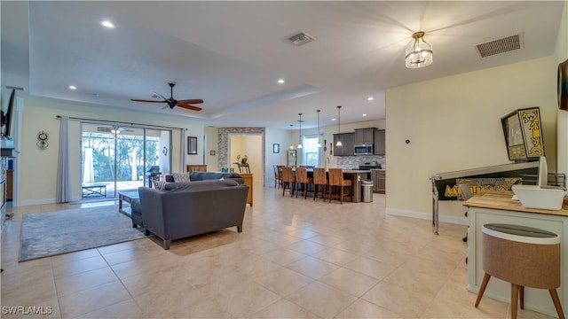 2541 SW 32nd Ln, Cape Coral, FL 33914 - living area featuring a tray ceiling, ceiling fan, light tile patterned floors, baseboards, and recessed lighting
