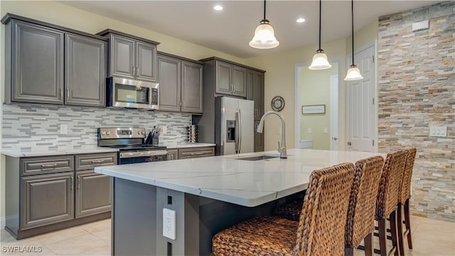 2541 SW 32nd Ln, Cape Coral, FL 33914 - kitchen featuring appliances with stainless steel finishes, light tile patterned floors, gray cabinets, a sink, and recessed lighting