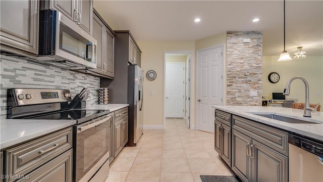 2541 SW 32nd Ln, Cape Coral, FL 33914 - kitchen with stainless steel appliances, a sink, backsplash, light tile patterned floors, and recessed lighting
